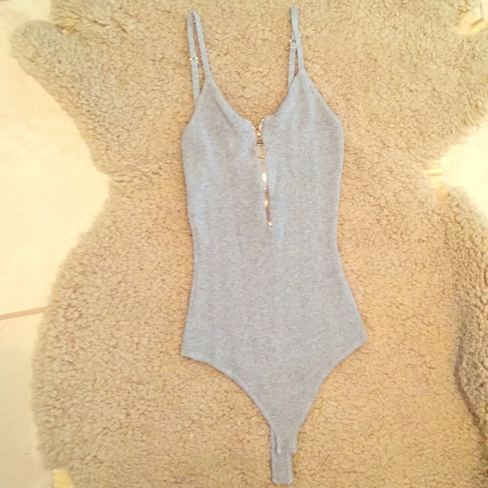 Grey body suit with gold zipper